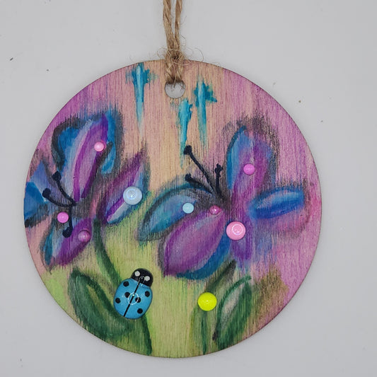 Butterfly-like flower with a blue ladybug